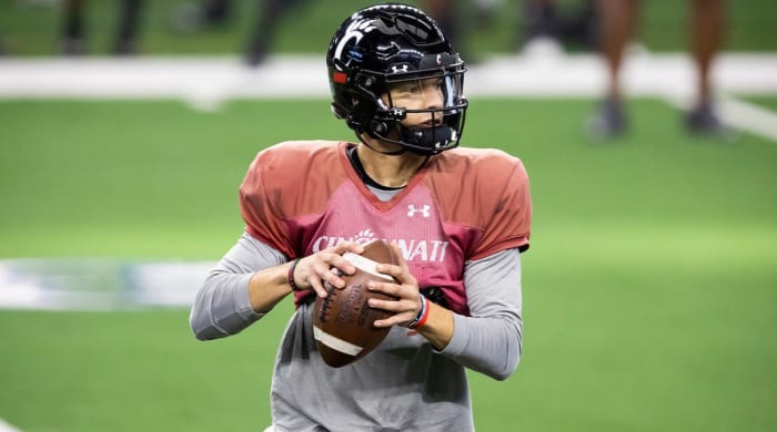 Cincinnati quarterback Desmond Ridder looks for an open receiver during practice for the Cotton Bowl NCAA football game, Monday, Dec. 27, 2021, in Arlington, Texas.